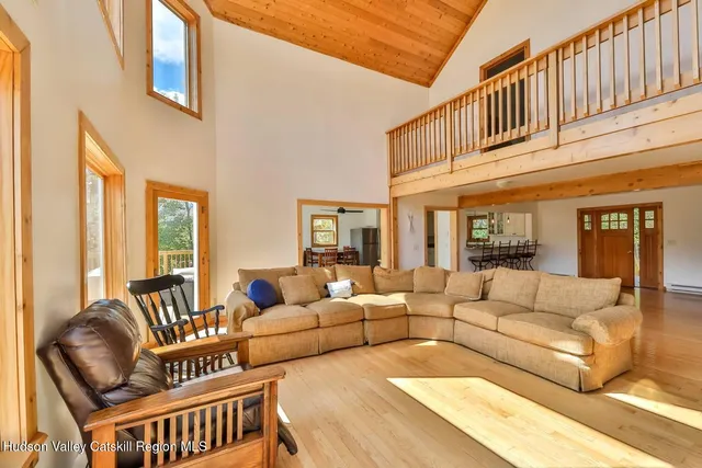 a living room with furniture ceiling fan and a rug