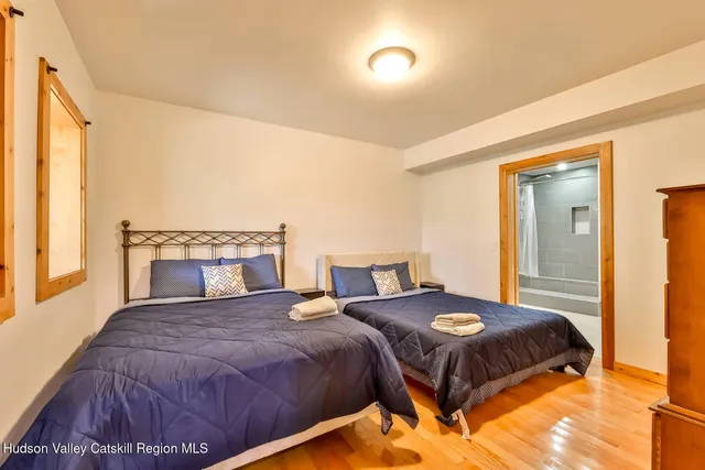 a bedroom with a bed and a potted plant