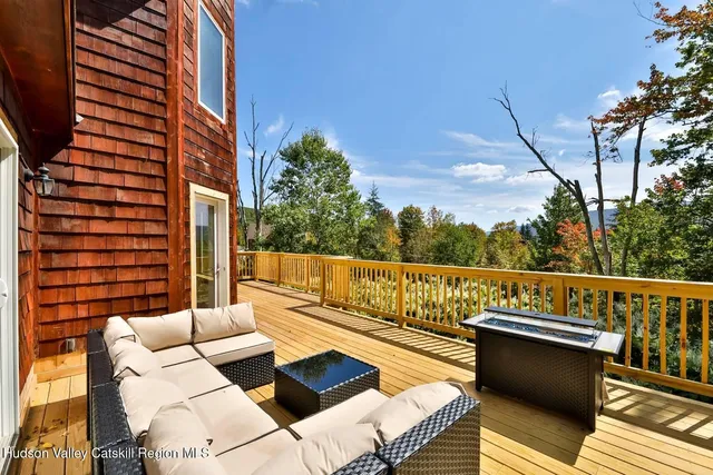 a view of balcony with couches and wooden floor