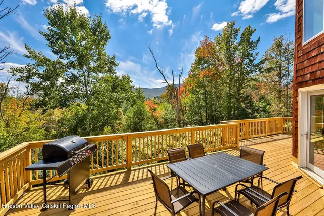 a view of a roof deck with wooden floor and fence