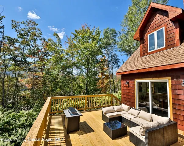 a view of a patio with couches table and chairs and potted plants