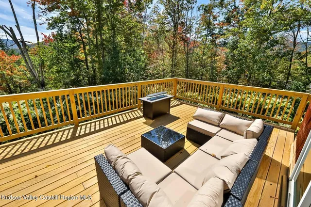 a view of balcony with wooden floor and seating space