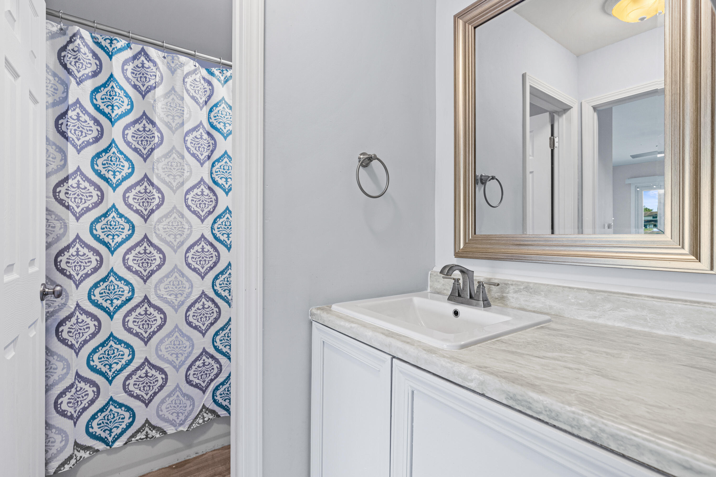210 Pelham Road, Unit 109B Fort Walton Beach, FL 32547 - Photo 11 of 33 a bathroom with a sink and a mirror