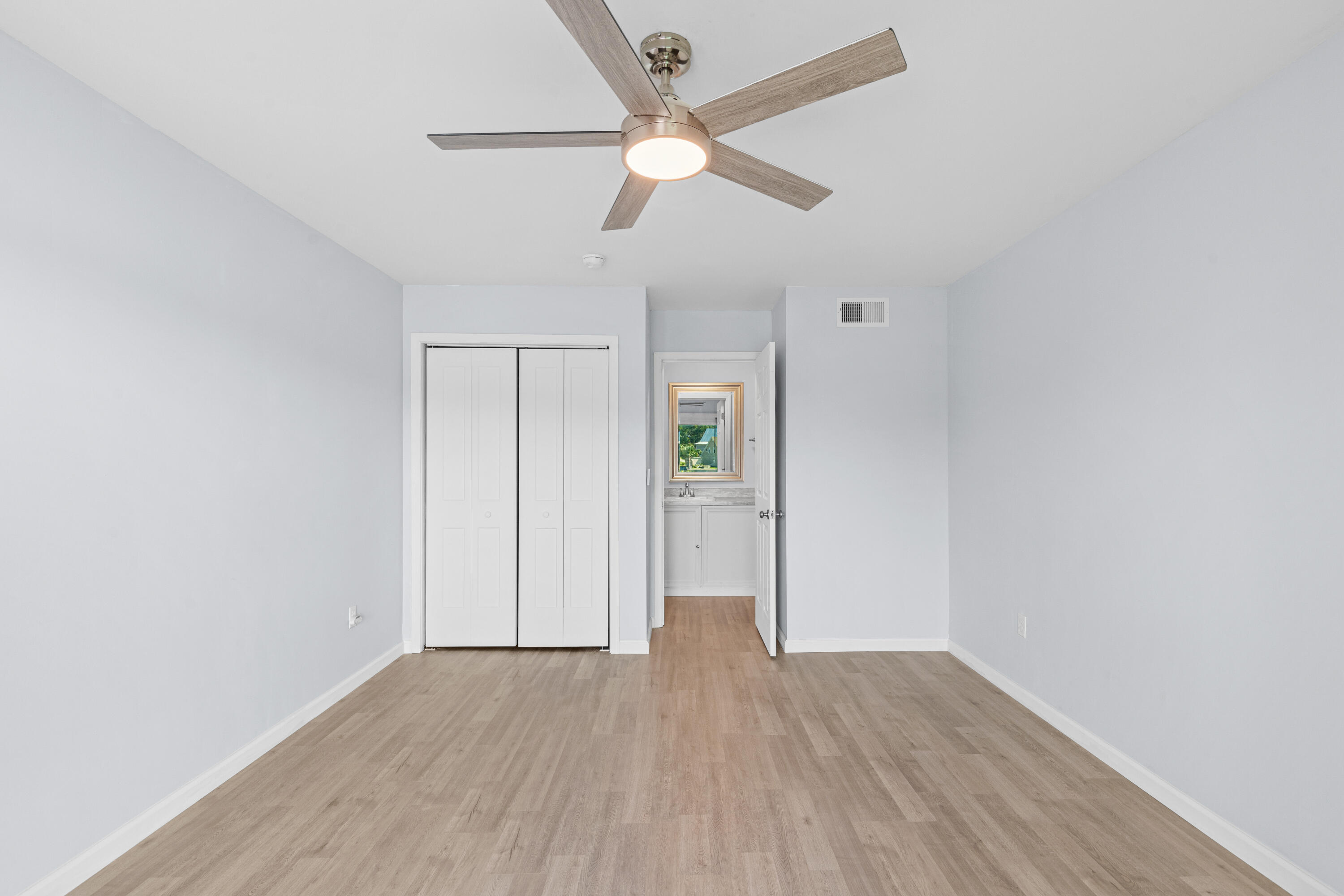 210 Pelham Road, Unit 109B Fort Walton Beach, FL 32547 - Photo 20 of 33 an empty room with wooden floor ceiling fan and window