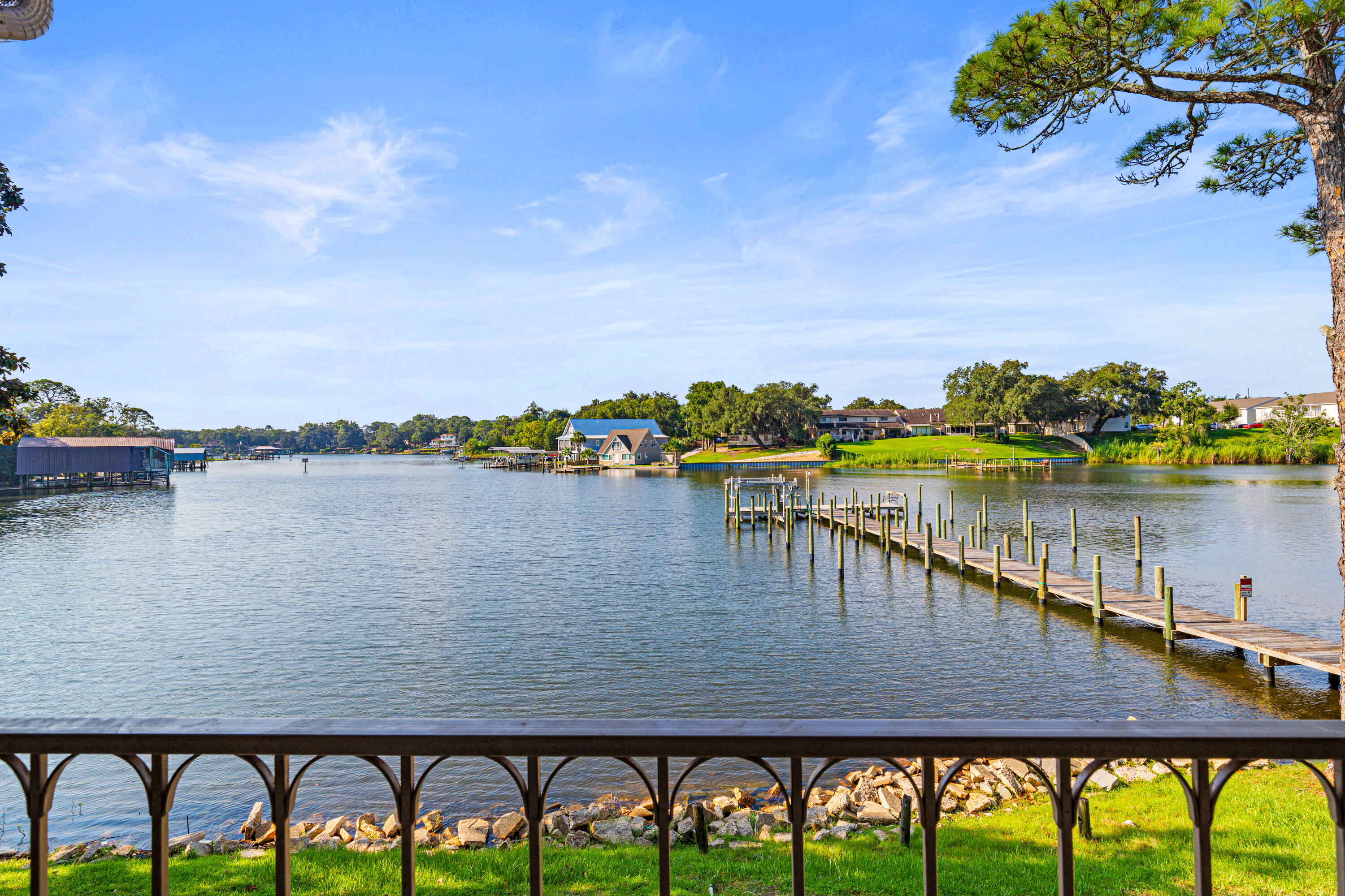 210 Pelham Road, Unit 109B Fort Walton Beach, FL 32547 - Photo 2 of 33 a view of a lake with houses in the back
