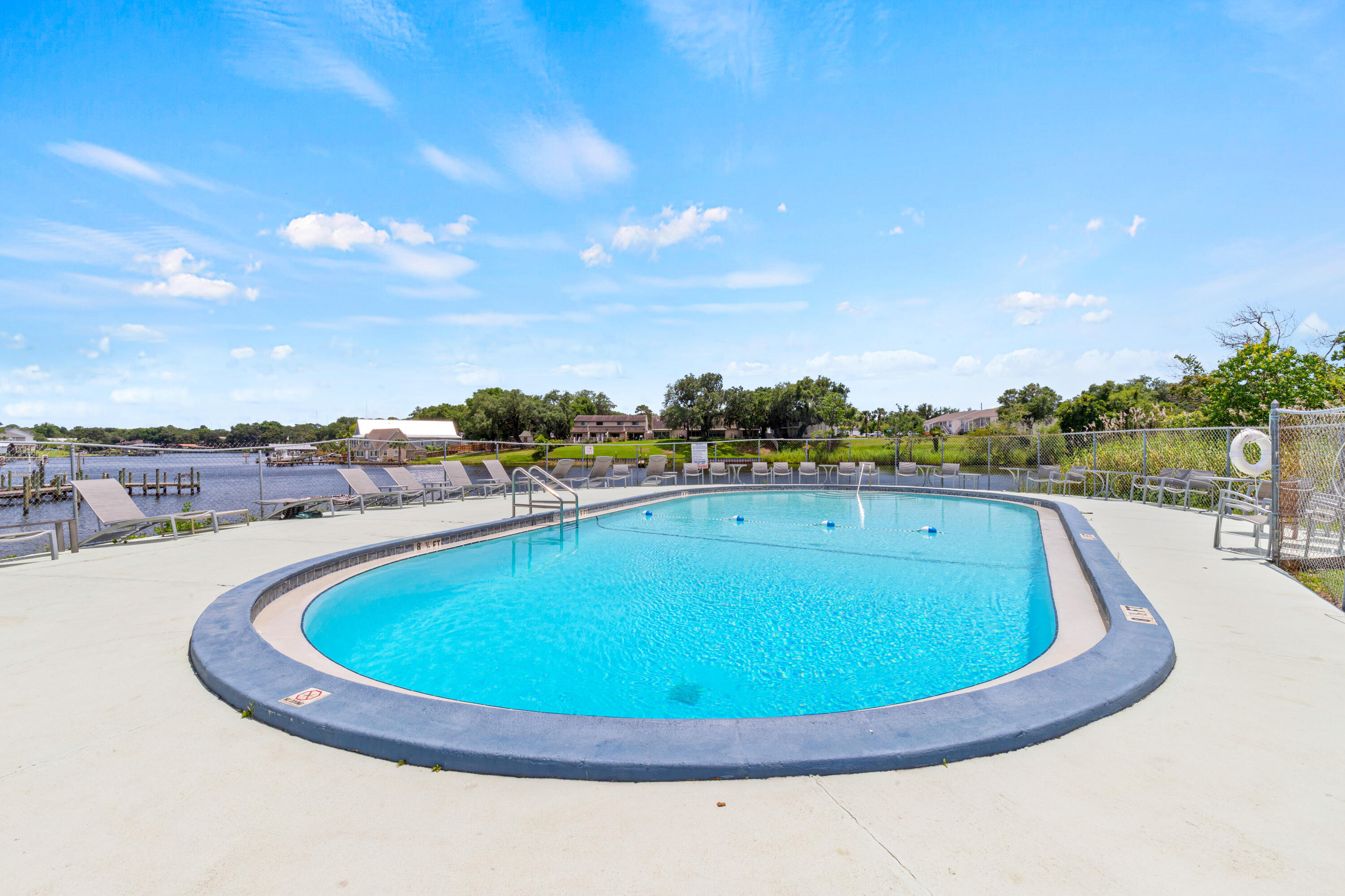 210 Pelham Road, Unit 109B Fort Walton Beach, FL 32547 - Photo 22 of 33 a view of a swimming pool with outdoor seating and plants