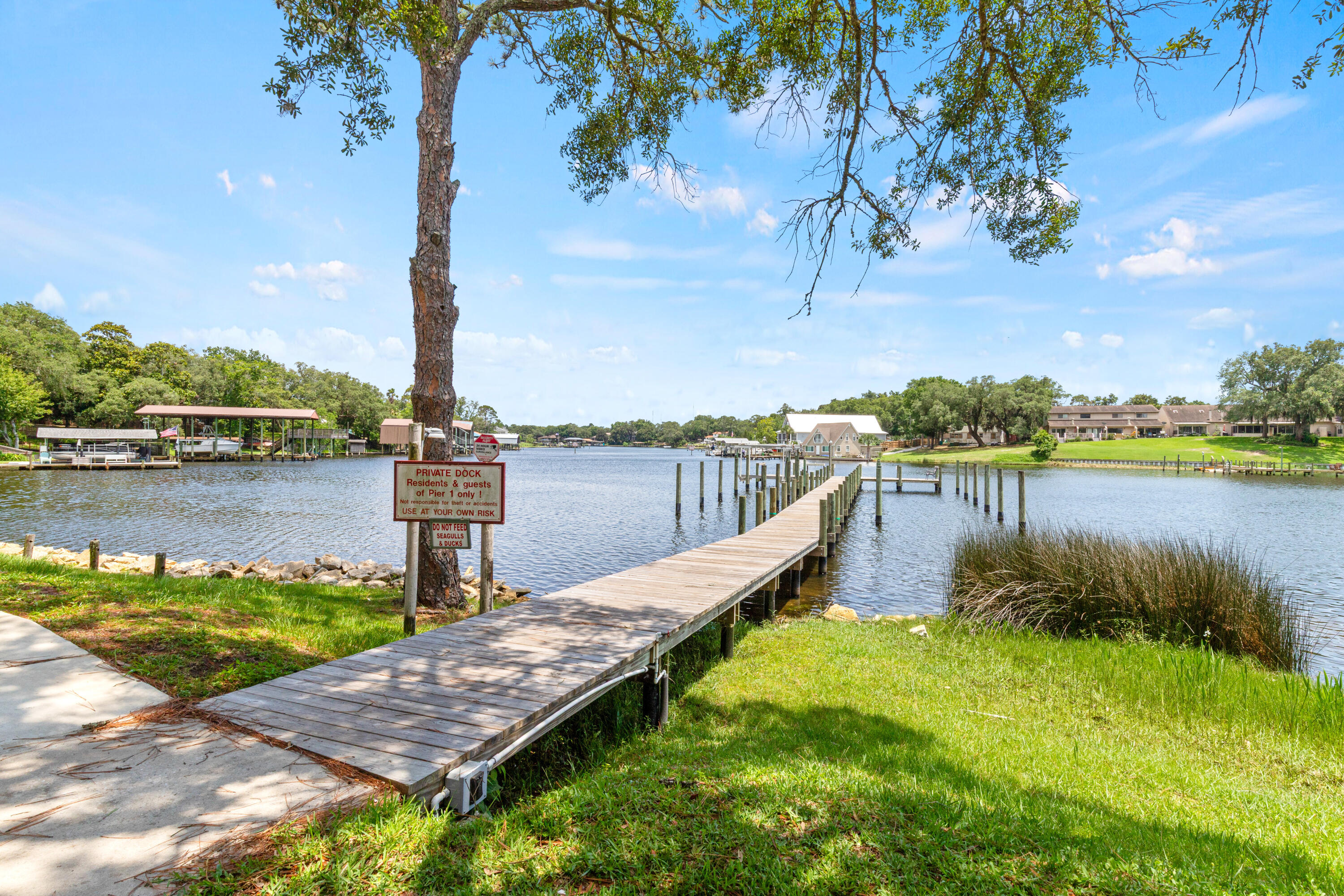 210 Pelham Road, Unit 109B Fort Walton Beach, FL 32547 - Photo 23 of 33 a view of a lake with houses in outdoor space