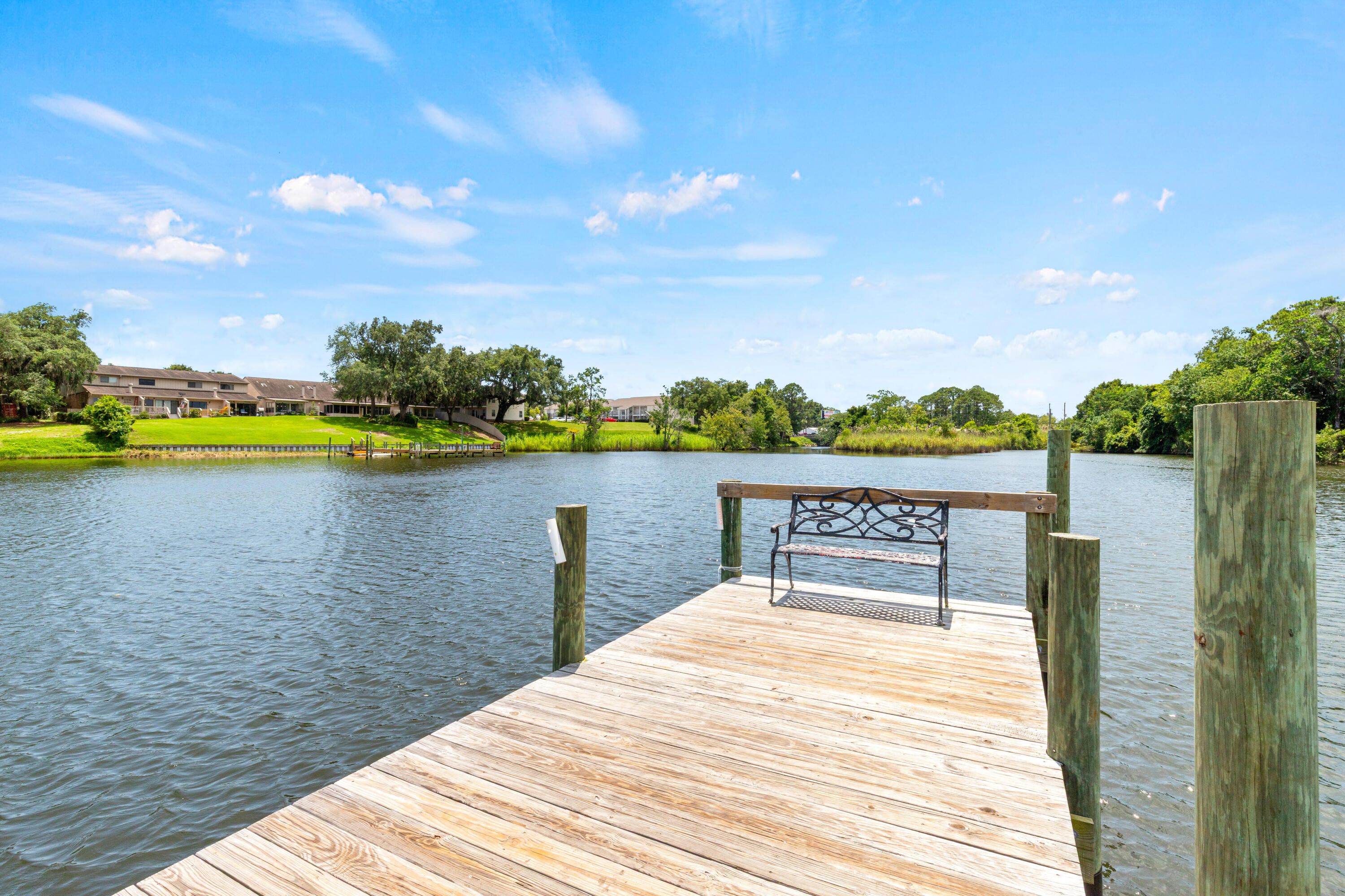 210 Pelham Road, Unit 109B Fort Walton Beach, FL 32547 - Photo 24 of 33 a view of a lake with houses in the back