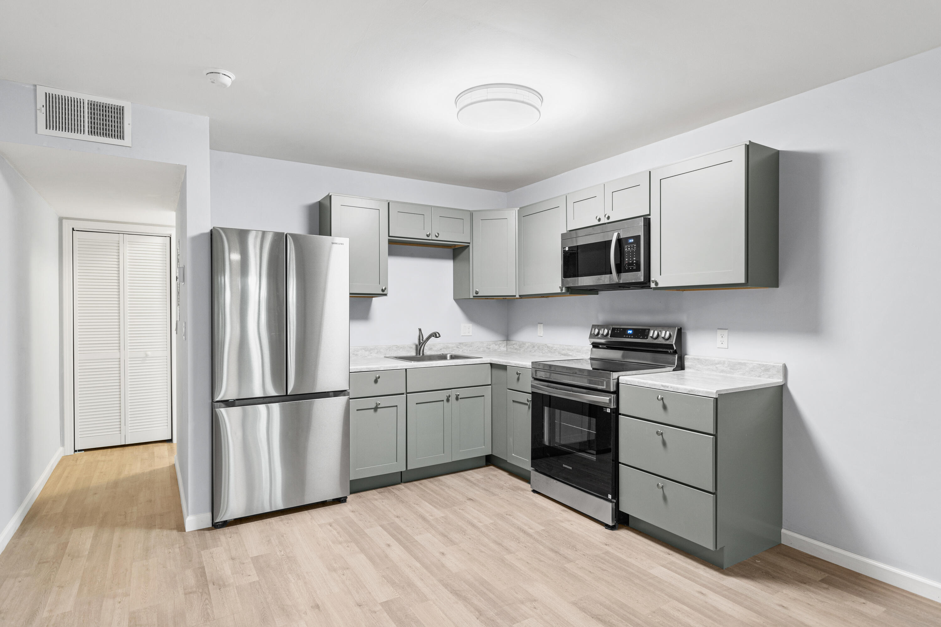 210 Pelham Road, Unit 109B Fort Walton Beach, FL 32547 - Photo 3 of 33 a kitchen with wooden cabinets and stainless steel appliances