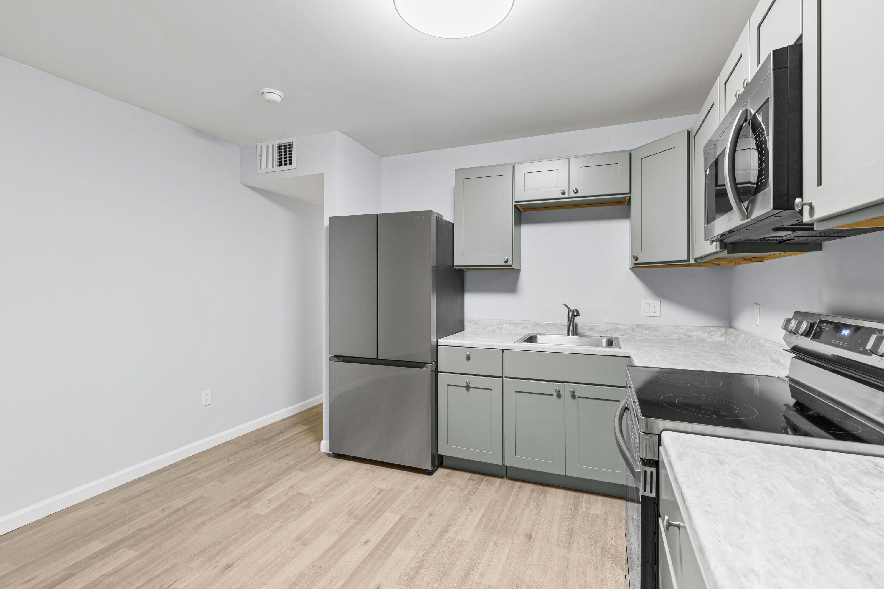 210 Pelham Road, Unit 109B Fort Walton Beach, FL 32547 - Photo 6 of 33 a kitchen with stainless steel appliances a sink a stove a refrigerator and cabinets