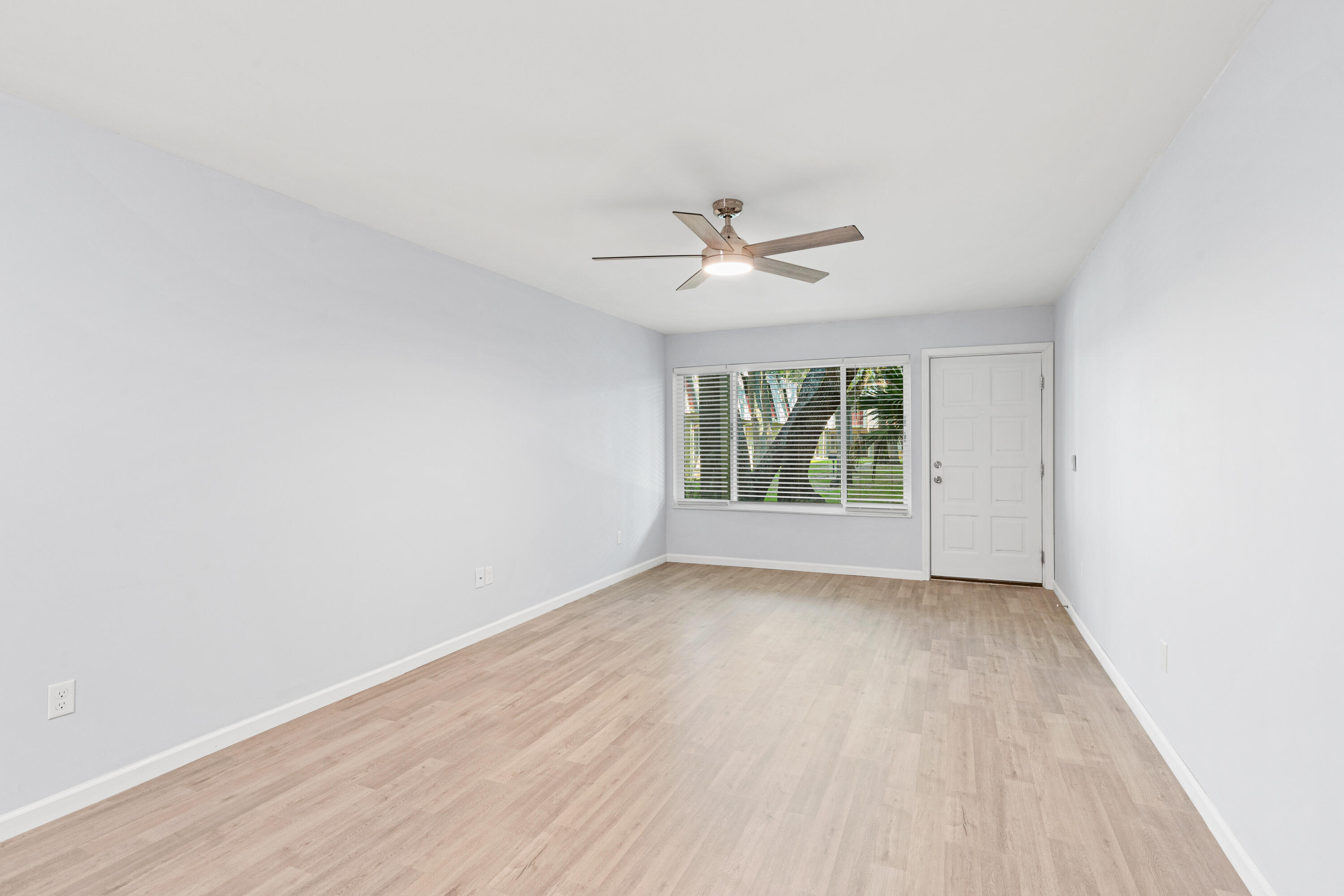 210 Pelham Road, Unit 109B Fort Walton Beach, FL 32547 - Photo 7 of 33 an empty room with wooden floor and windows