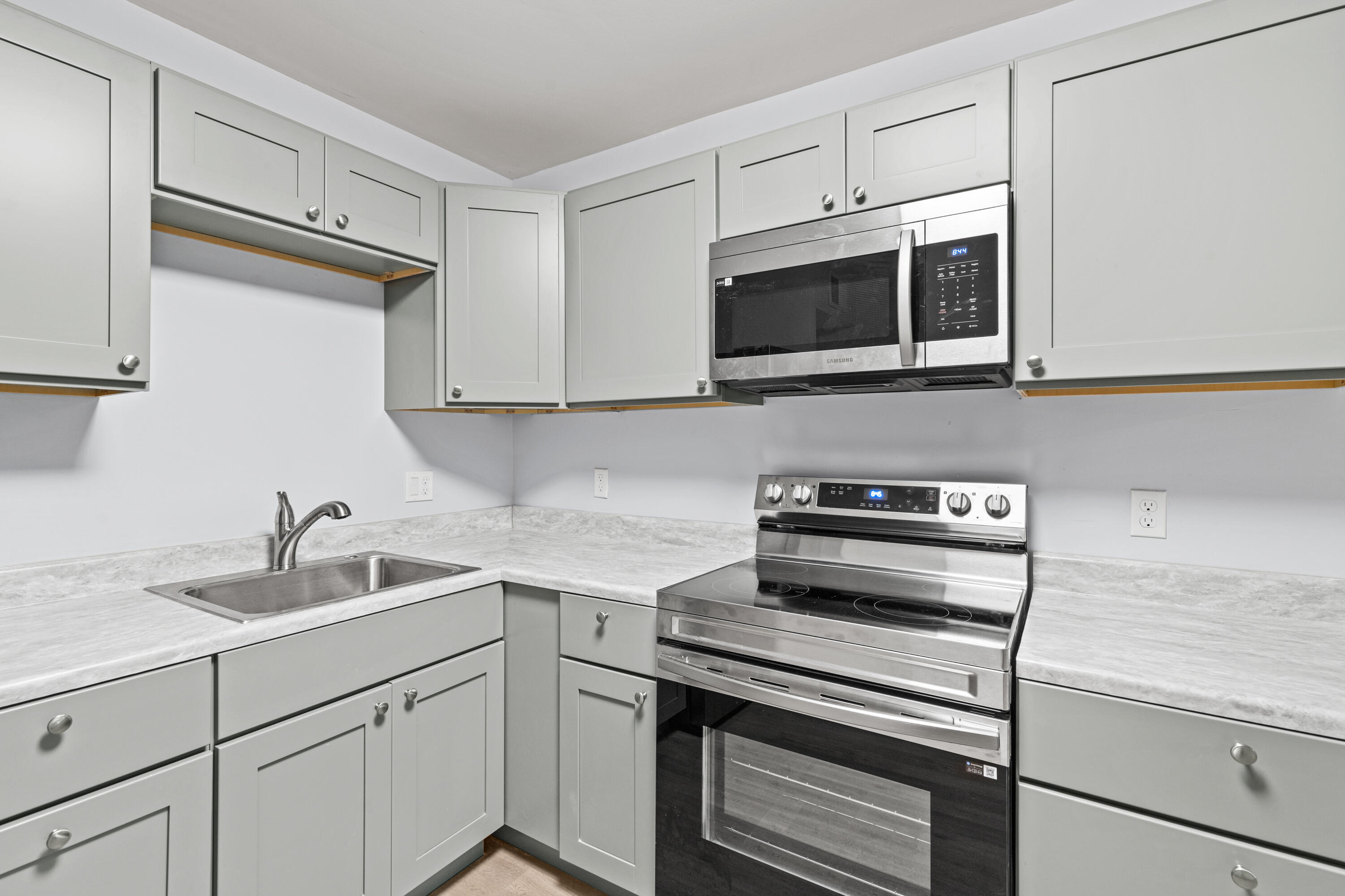 210 Pelham Road, Unit 109B Fort Walton Beach, FL 32547 - Photo 10 of 33 a kitchen with white cabinets stainless steel appliances and a sink