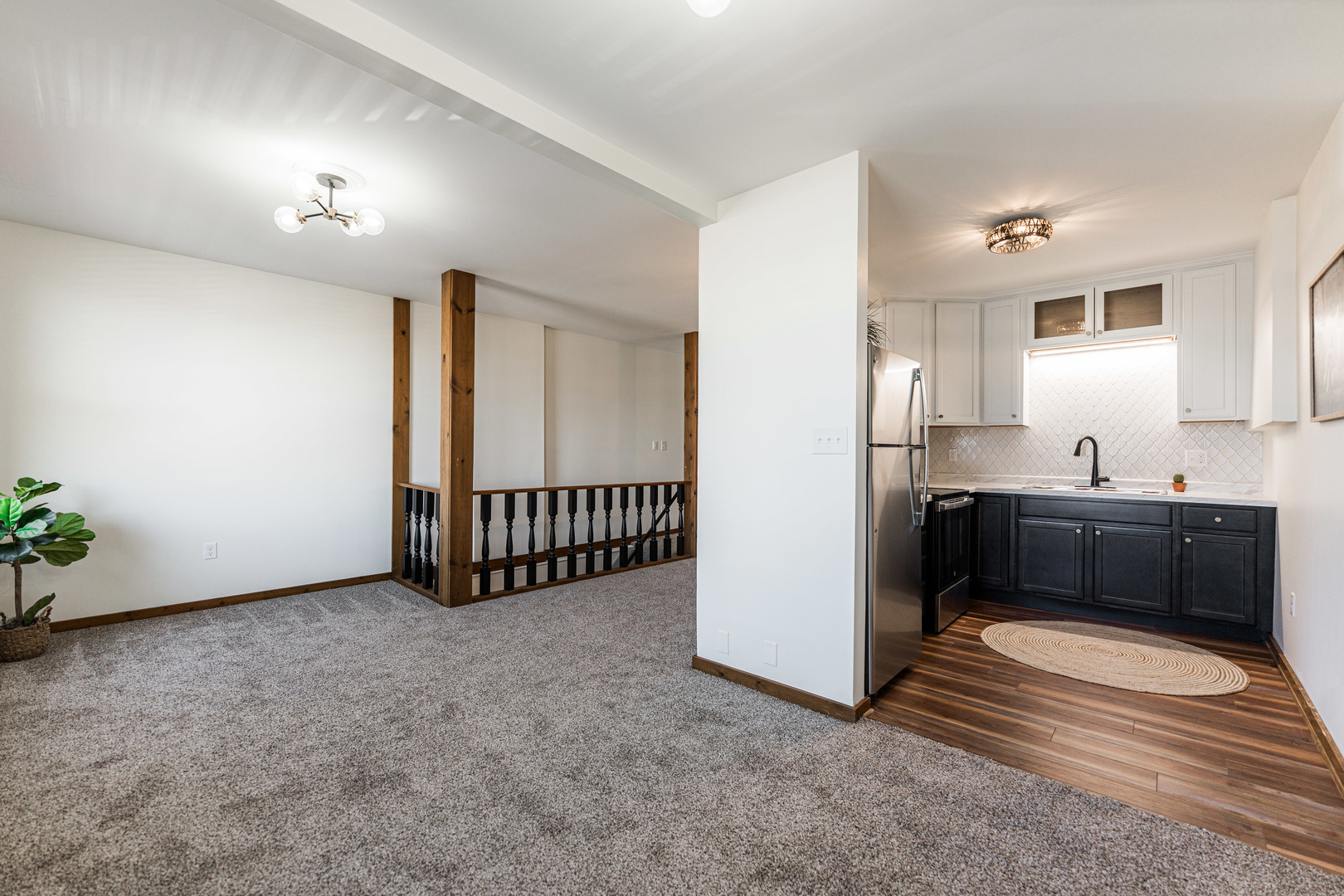 318 West State Street, Unit 318 Sycamore, IL 60178 - Photo 11 of 21 a view of a room with a fridge and wooden floor