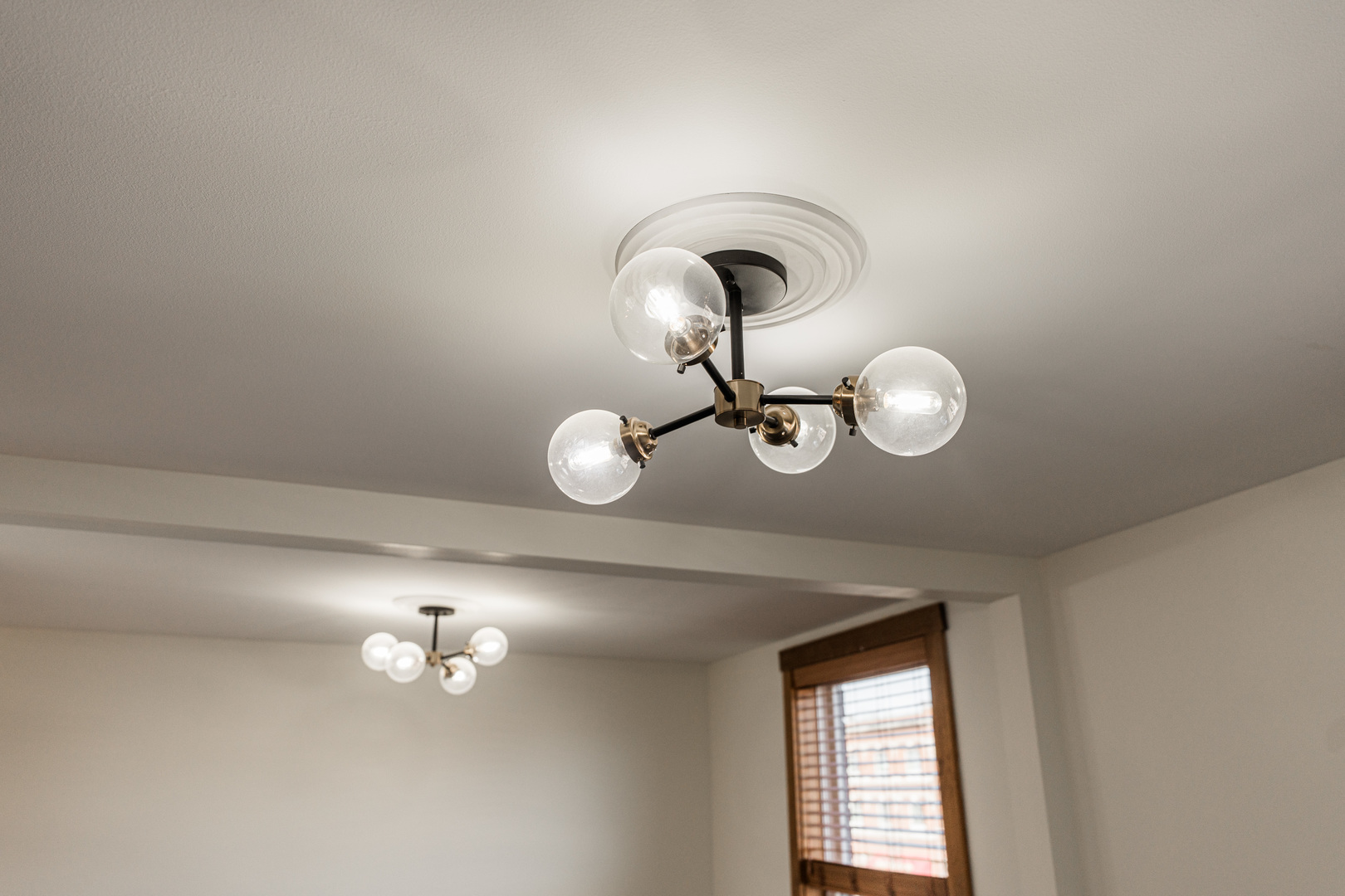 318 West State Street, Unit 318 Sycamore, IL 60178 - Photo 18 of 21 a view of a room with a chandelier fan and window