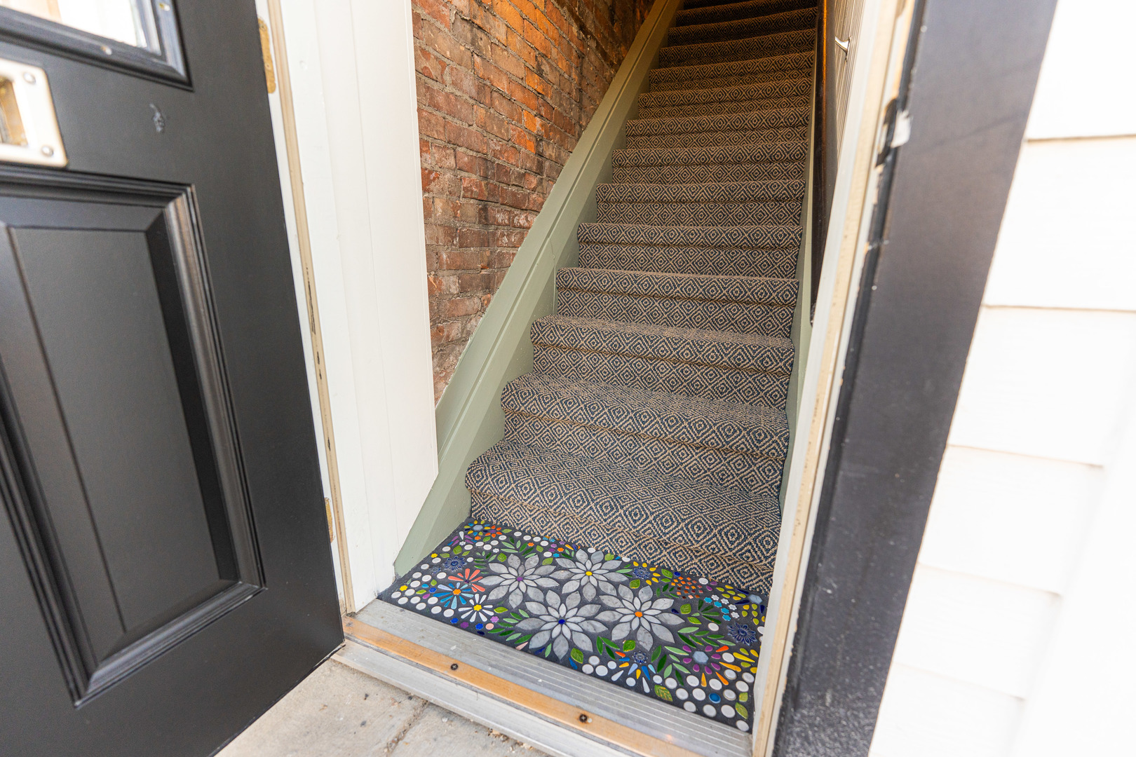 318 West State Street, Unit 318 Sycamore, IL 60178 - Photo 3 of 21 a view of staircase with white walls and black door