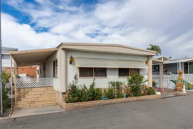 a front view of a house with a garden