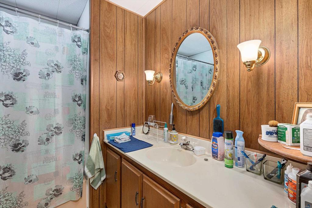 65 Brookside Lane Oceanside, CA 92056 - Photo 23 of 28 a bathroom with a sink mirror and vanity