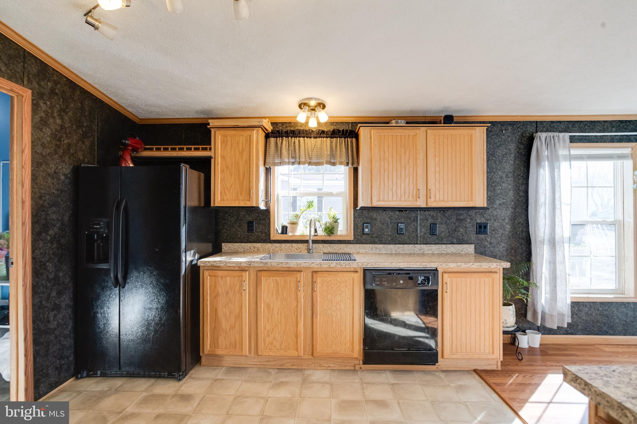 488 North Patuxent Road, Unit 18A Odenton, MD 21113 - Photo 13 of 34 a kitchen with a refrigerator and cabinets