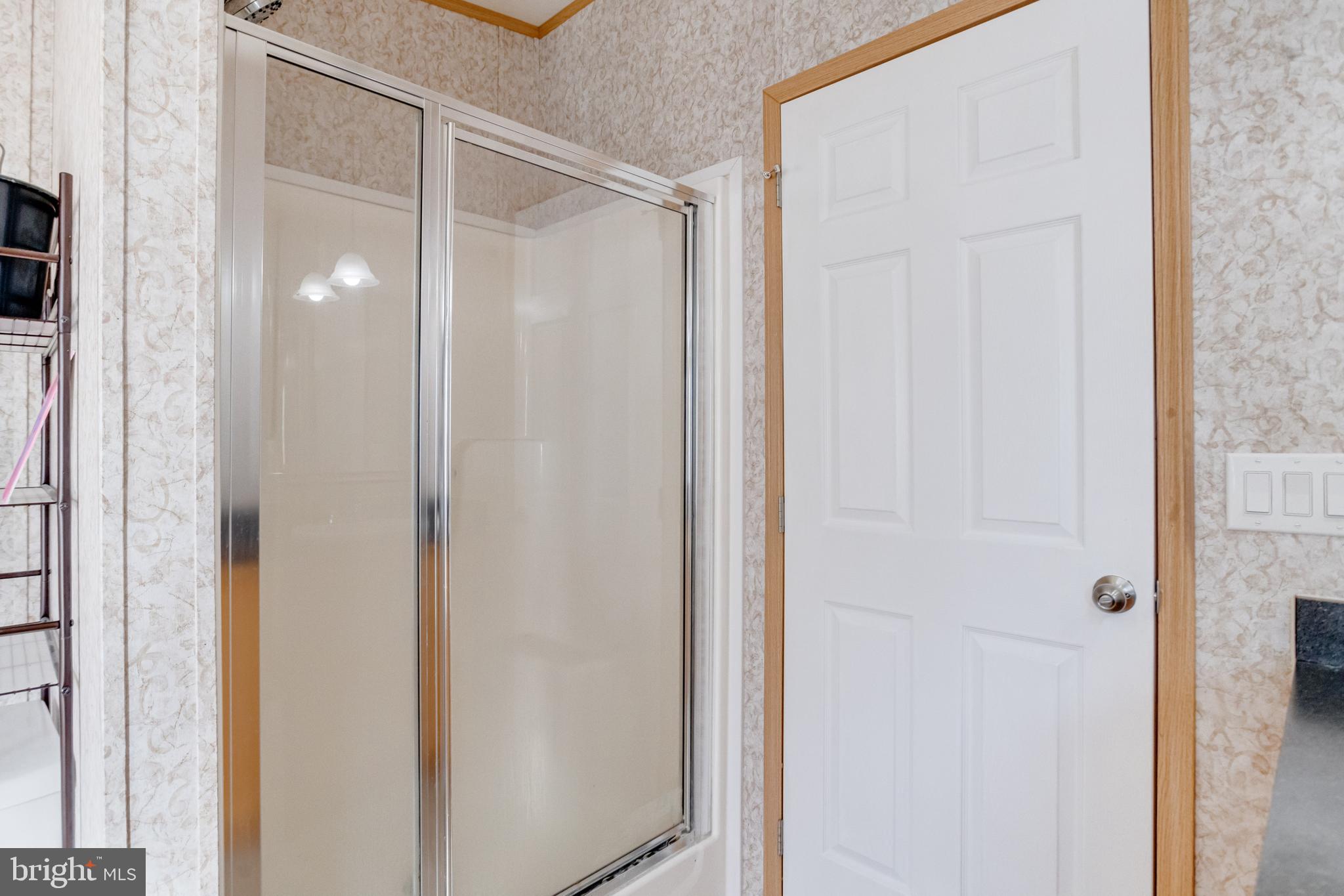488 North Patuxent Road, Unit 18A Odenton, MD 21113 - Photo 23 of 34 a bathroom with a glass shower door