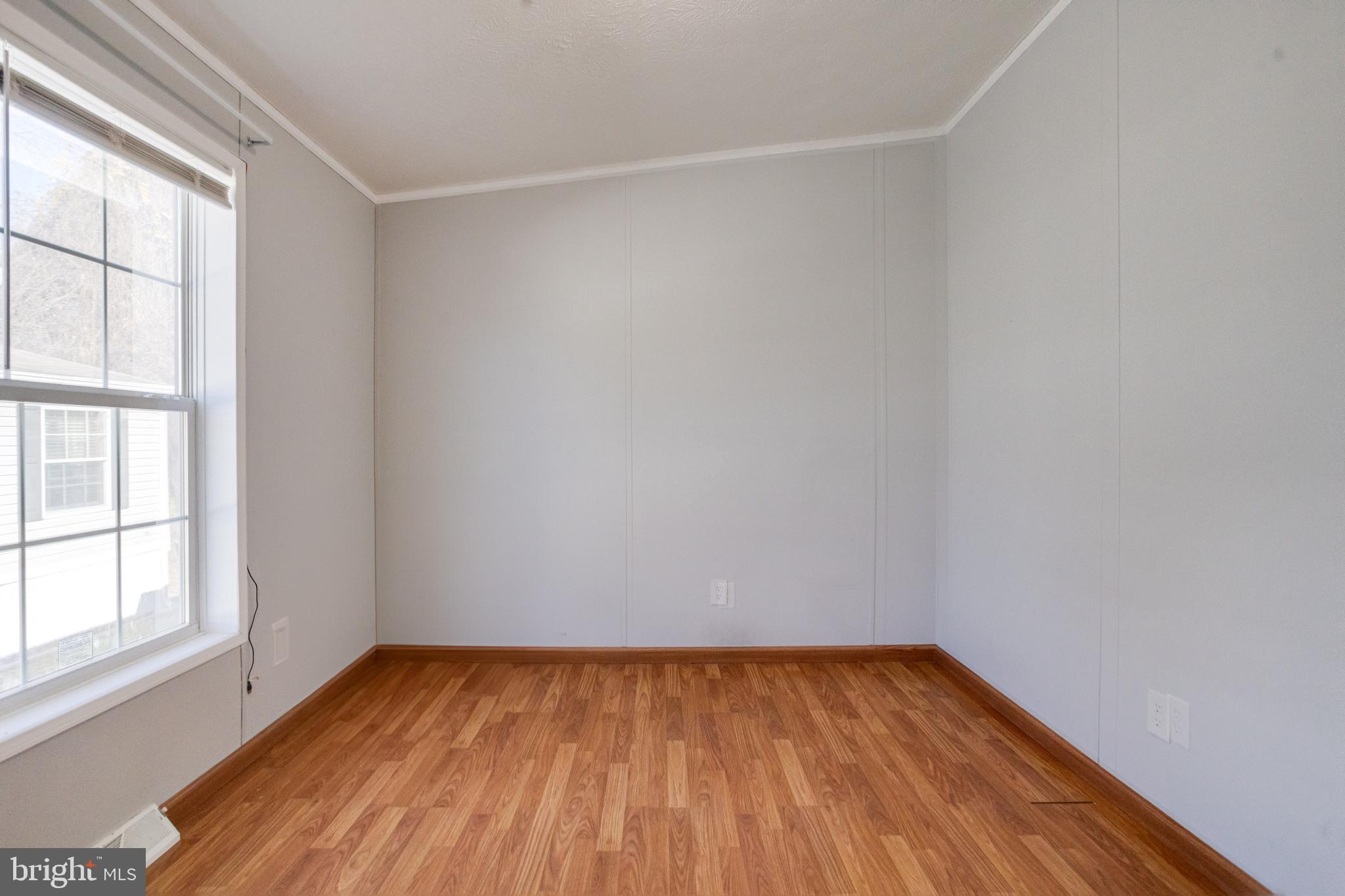 488 North Patuxent Road, Unit 18A Odenton, MD 21113 - Photo 27 of 34 a view of an empty room with wooden floor and a window