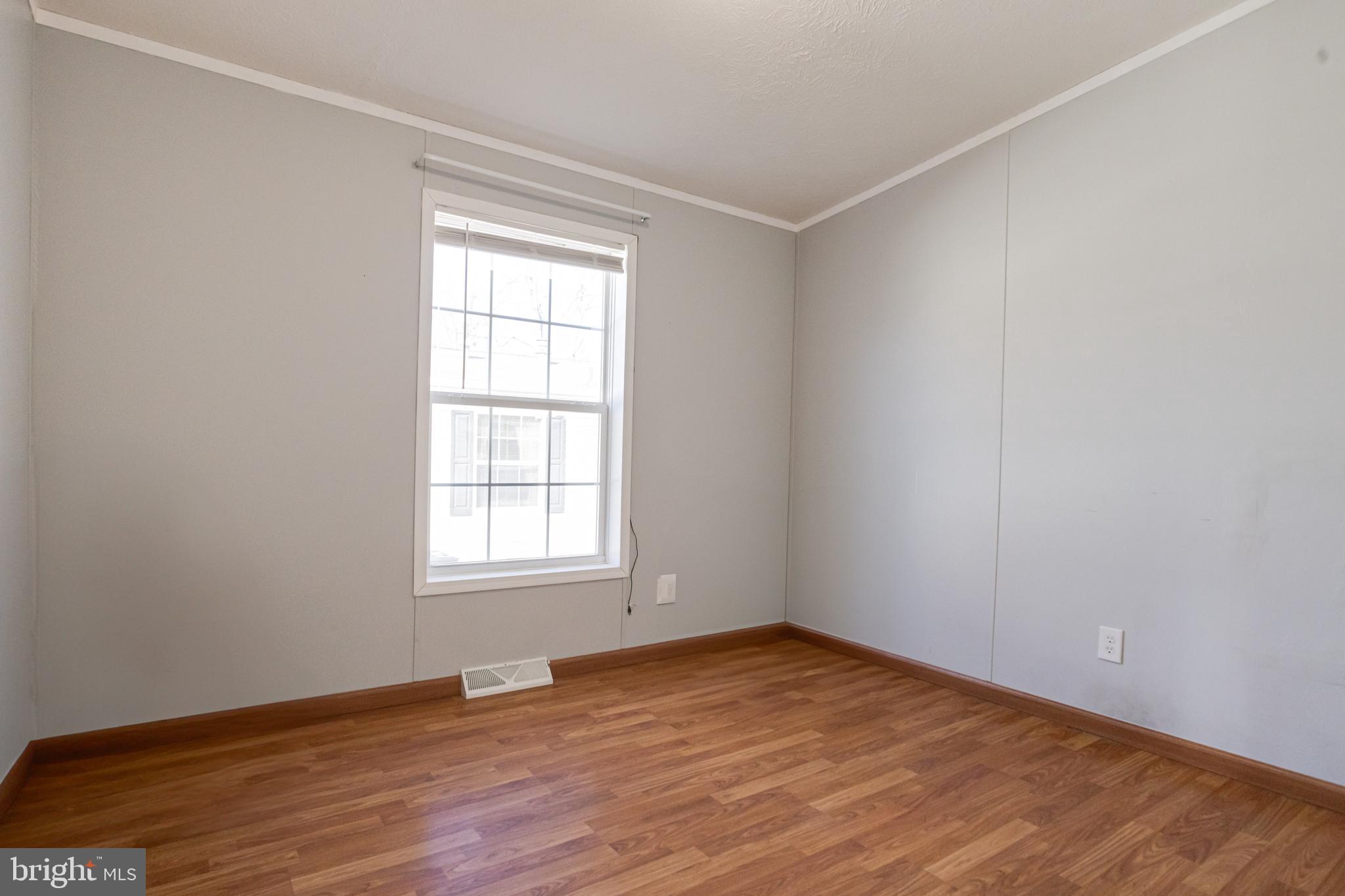 488 North Patuxent Road, Unit 18A Odenton, MD 21113 - Photo 28 of 34 an empty room with wooden floor and windows