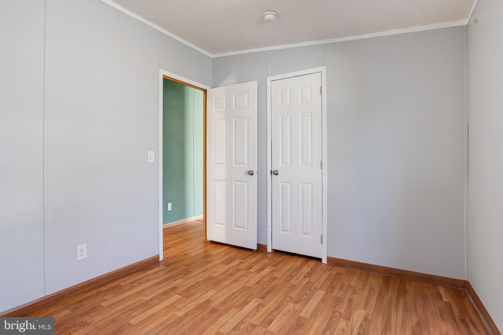 488 North Patuxent Road, Unit 18A Odenton, MD 21113 - Photo 29 of 34 a view of an empty room with wooden floor and closet