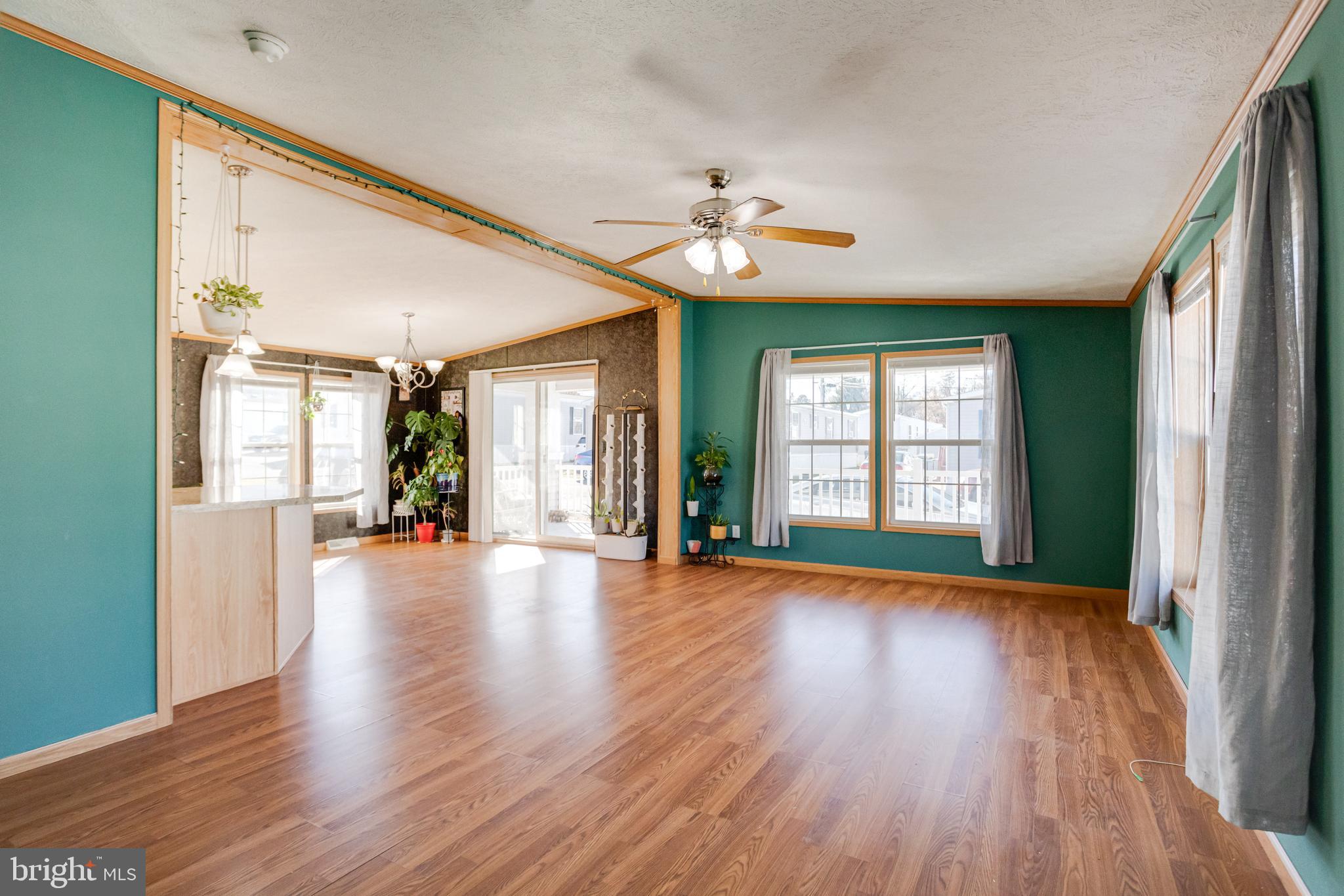 488 North Patuxent Road, Unit 18A Odenton, MD 21113 - Photo 3 of 34 a view of an empty room with wooden floor and a window