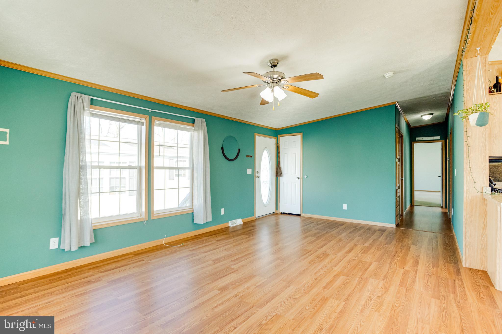 488 North Patuxent Road, Unit 18A Odenton, MD 21113 - Photo 7 of 34 a view of an empty room with a window and wooden floor
