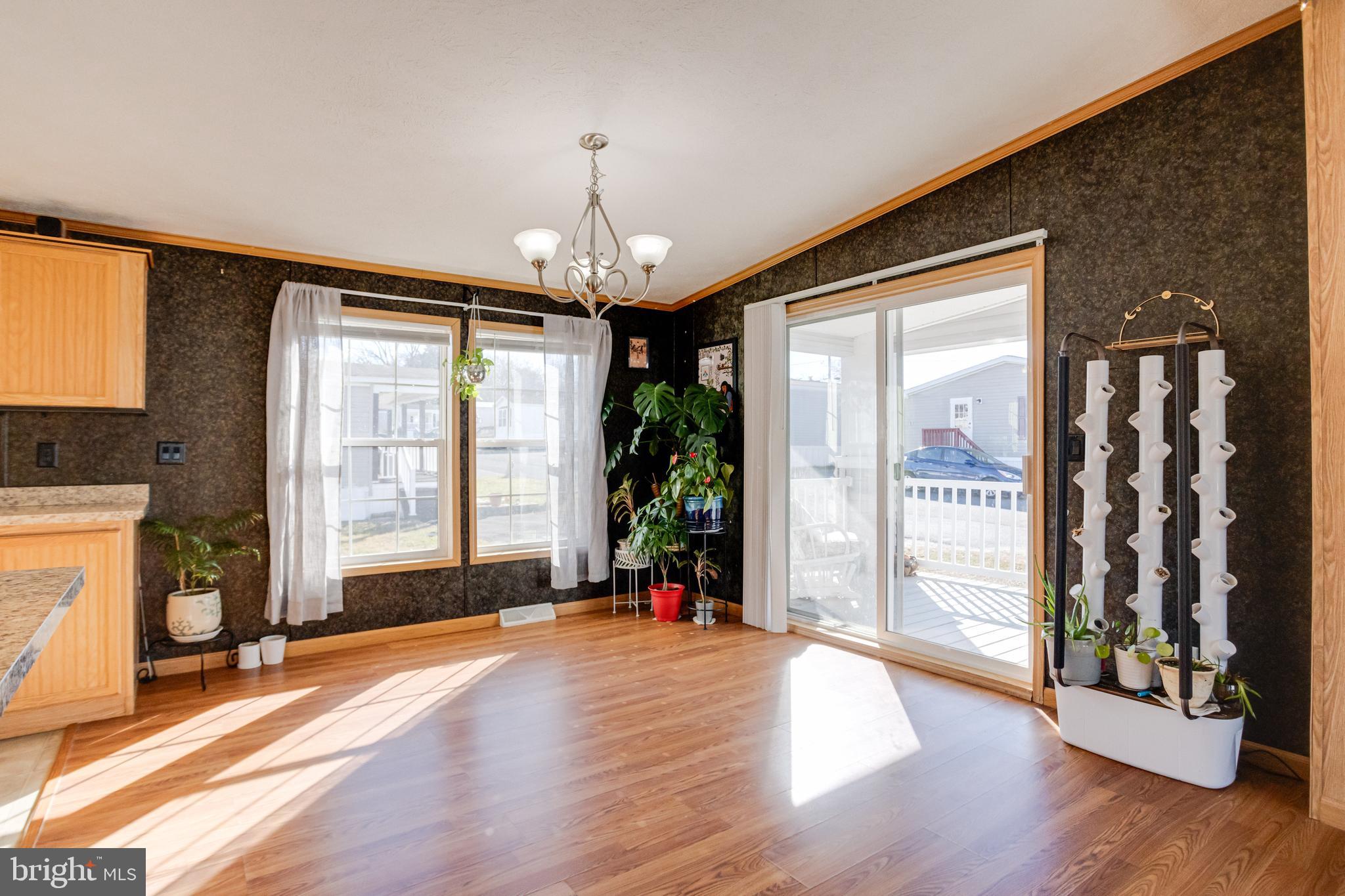 488 North Patuxent Road, Unit 18A Odenton, MD 21113 - Photo 10 of 34 a view of a livingroom with wooden floor and a large window
