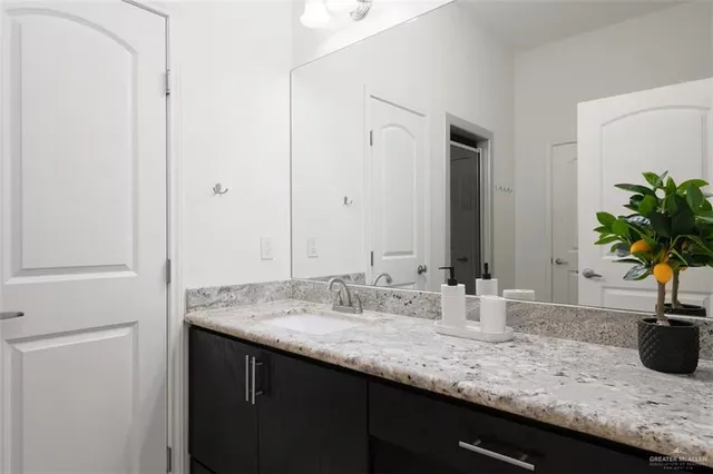 a view of a bedroom with bed and flat tv screen