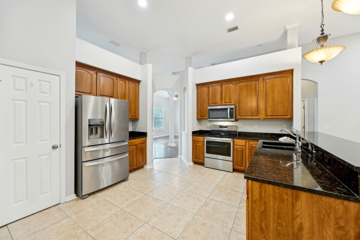 96286 Springwood Lane Fernandina Beach, FL 32034 - Photo 6 of 59 Wide open kitchen, tile floors, stainless appliances, granite counters
