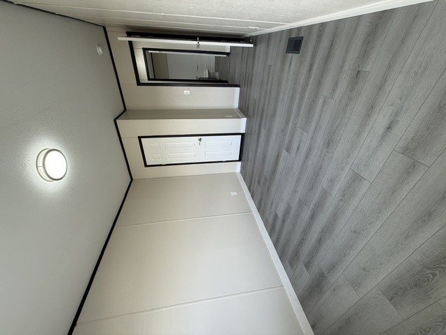393 Duchess Pass Kyle, TX 78640 - Photo 11 of 14 Clean lines and light vinyl flooring extend through this inviting bedroom.