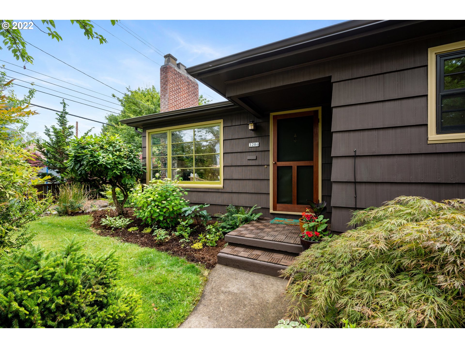 a couple of flower plants in front of door