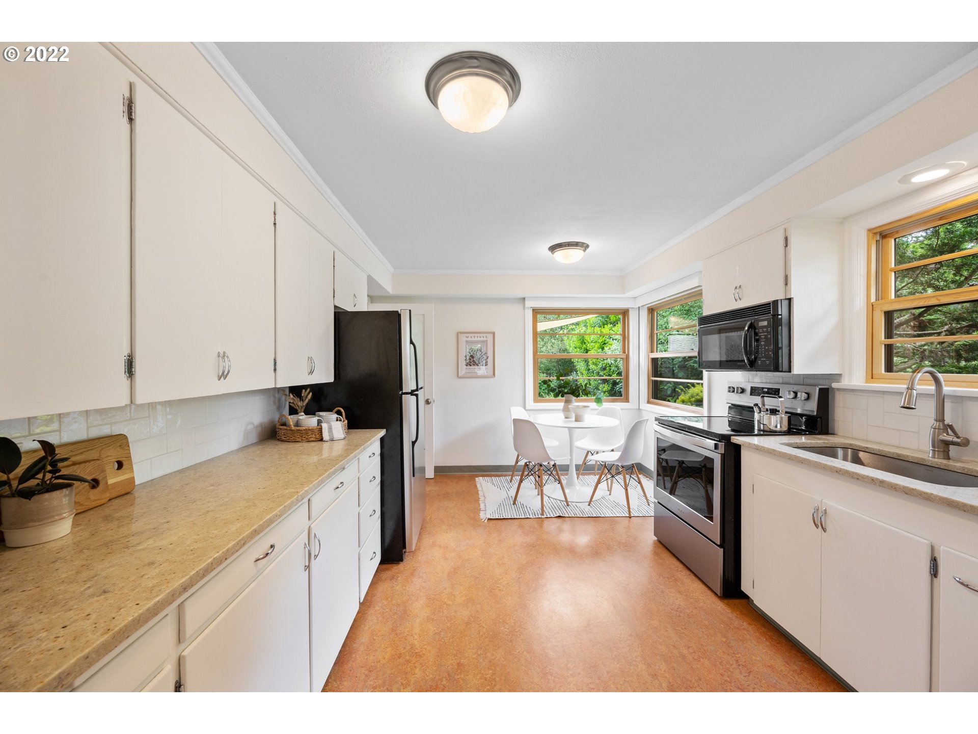 3286 Northeast Holman Street Portland, OR 97211 - Photo 12 of 25 a kitchen with lots of counter top space and living room