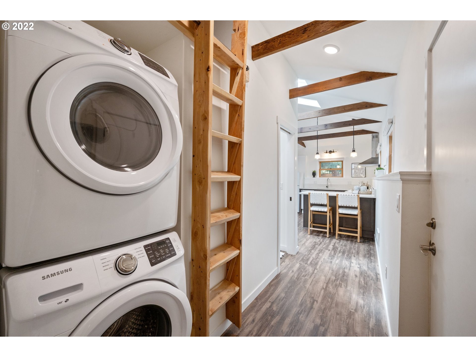 3286 Northeast Holman Street Portland, OR 97211 - Photo 19 of 25 a view of washer and dryer with kitchen in the background
