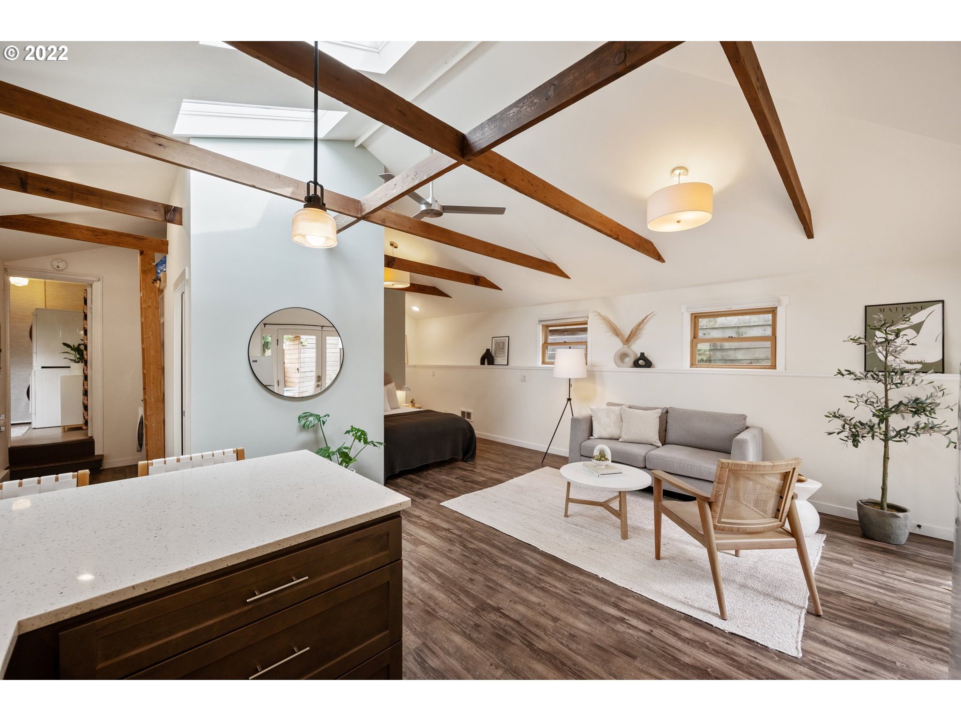 3286 Northeast Holman Street Portland, OR 97211 - Photo 5 of 25 a living room with couches a dining table with wooden floor