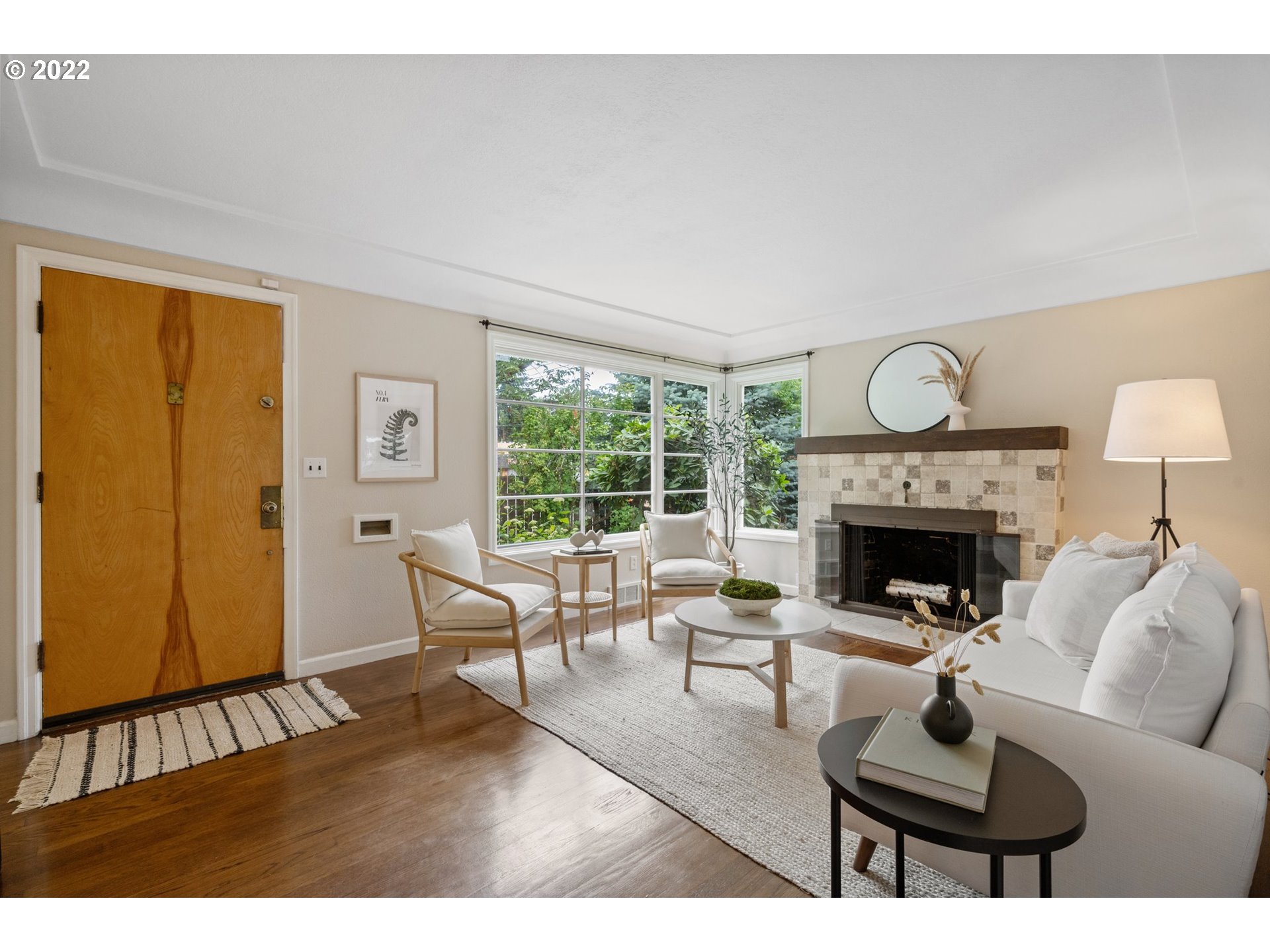 3286 Northeast Holman Street Portland, OR 97211 - Photo 10 of 25 a living room with furniture a fireplace and a window