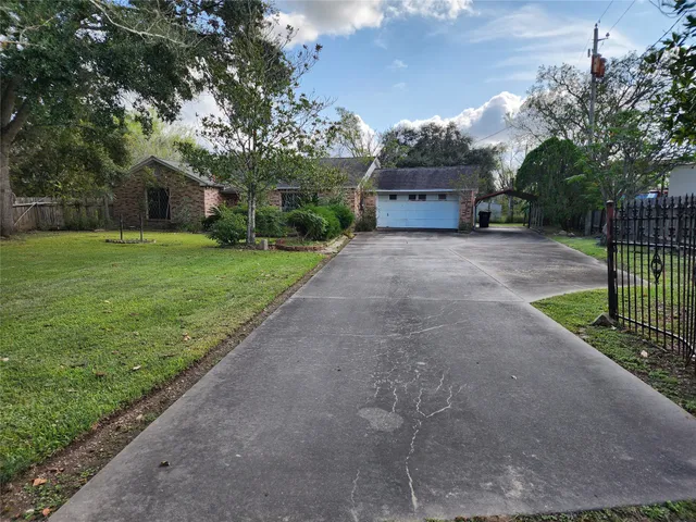 a front view of a house with a garden and trees