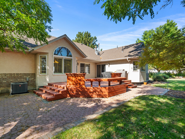 13357 Trail Rider Circle Draper, UT 84020 - Photo 51 of 70 Expansive backyard featuring a multi-level wood deck, a patio with brick pavers, and a manicured lawn