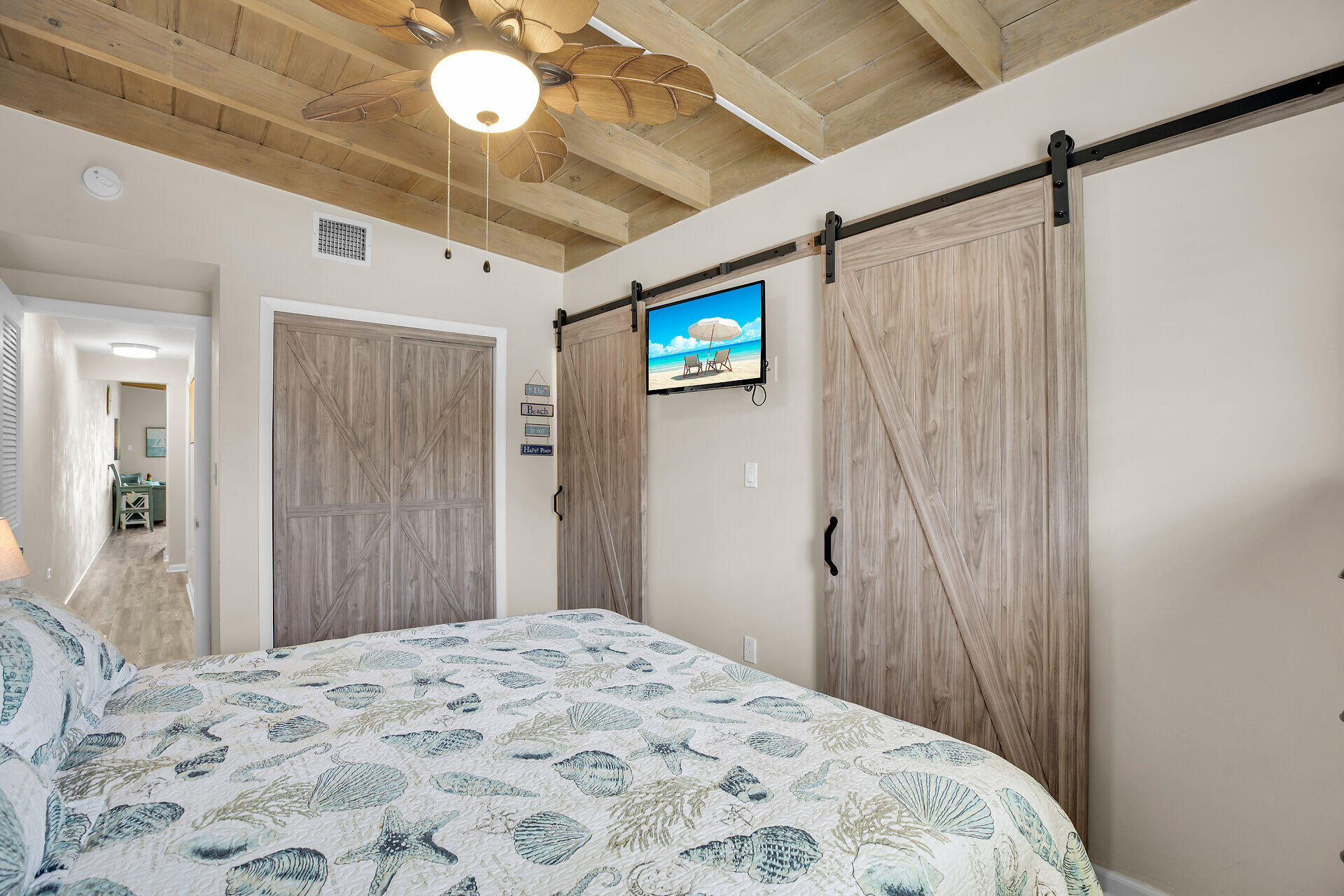 211 5th Street Key Colony Beach, FL 33051 - Photo 15 of 28 a bedroom with a bed and a chandelier