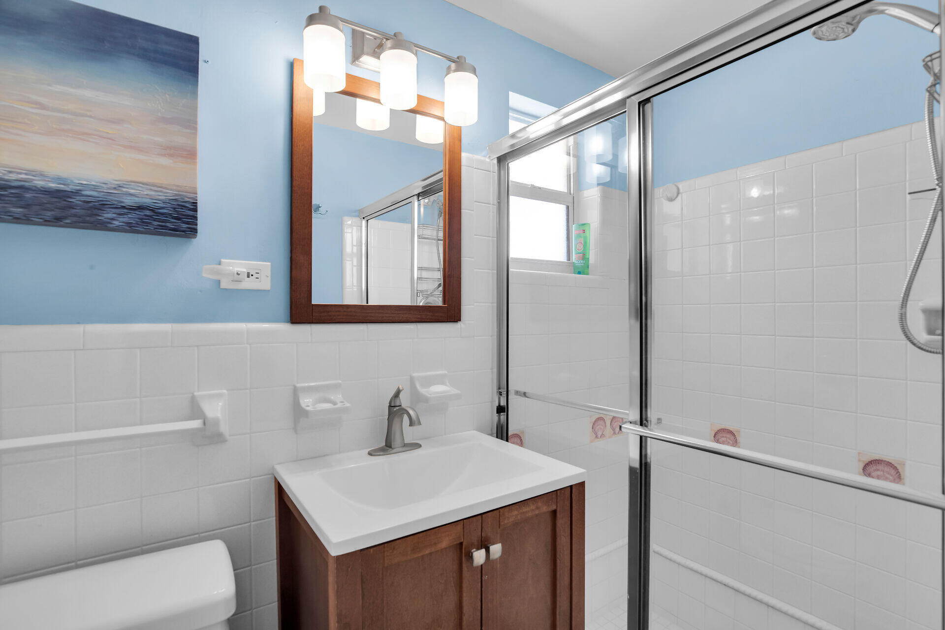 211 5th Street Key Colony Beach, FL 33051 - Photo 16 of 28 a bathroom with a sink toilet vanity and mirror