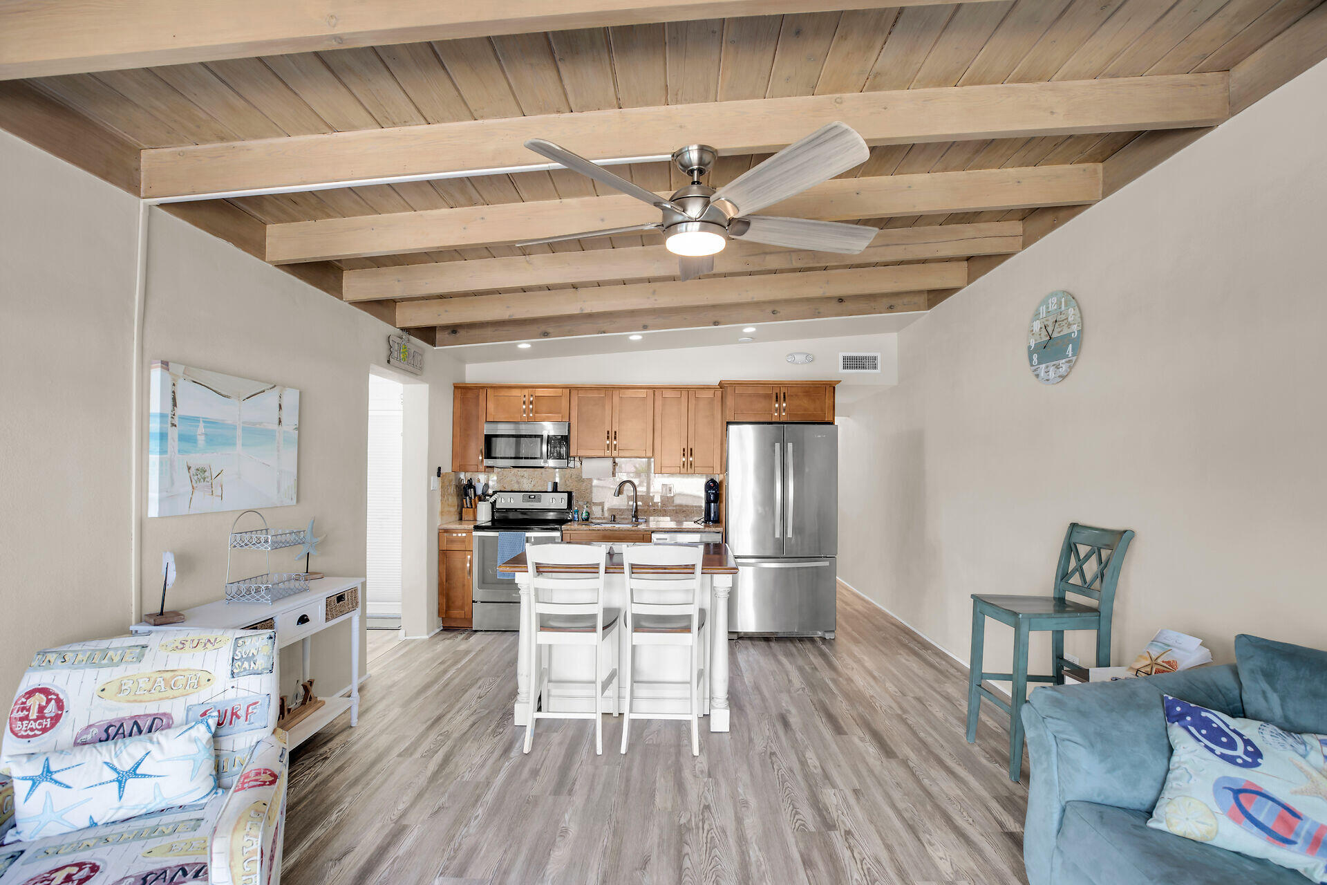 211 5th Street Key Colony Beach, FL 33051 - Photo 5 of 28 a view of a dining room with furniture a chandelier and wooden floor