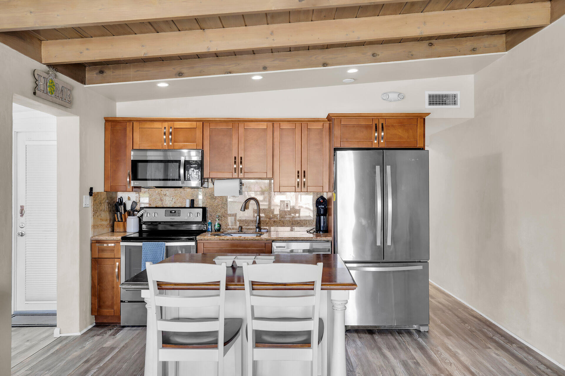 211 5th Street Key Colony Beach, FL 33051 - Photo 6 of 28 a kitchen with stainless steel appliances a refrigerator and a stove top oven