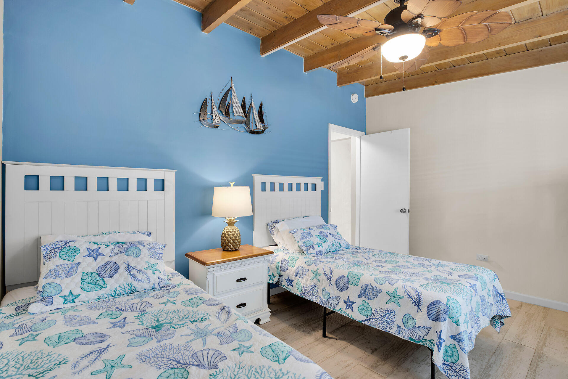 211 5th Street Key Colony Beach, FL 33051 - Photo 9 of 28 a bedroom with a bed and a chandelier