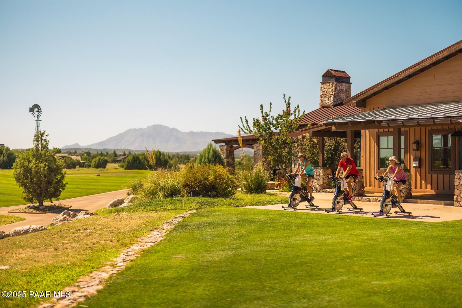 5350 West Simmons Peak Road Prescott, AZ 86305 - Photo 15 of 24 a view of a swimming pool with a lawn chairs under an umbrella