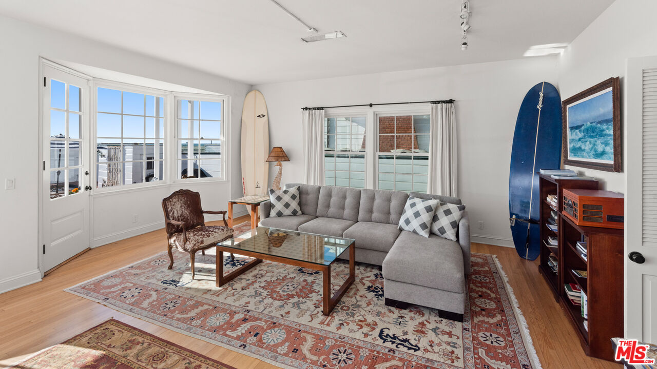 605 Palisades Beach Road Santa Monica, CA 90402 - Photo 13 of 33 a living room with furniture a rug and a window