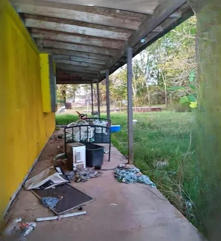 a view of a patio with table and chairs potted plants with floor to ceiling window