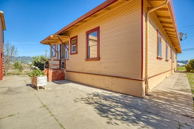 a view of a house with wooden fence