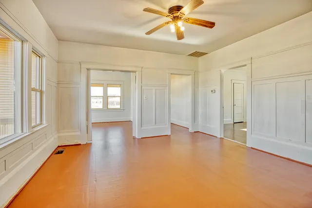 wooden floor in an empty room with a window