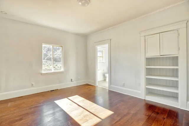 a kitchen with a sink and wooden floor